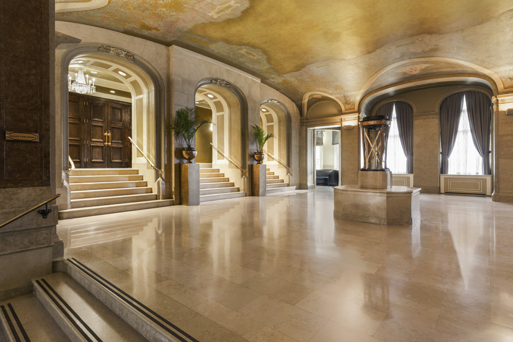 a large room with marble floor and stairs