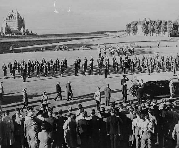 a group of people standing in front of a military parade