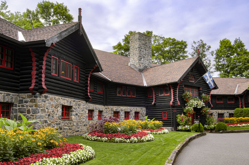 a house with a garden and a stone chimney