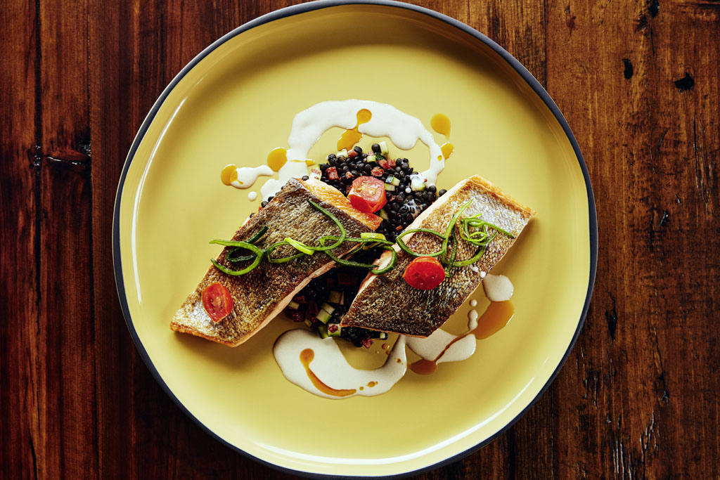a plate of food on a wood table