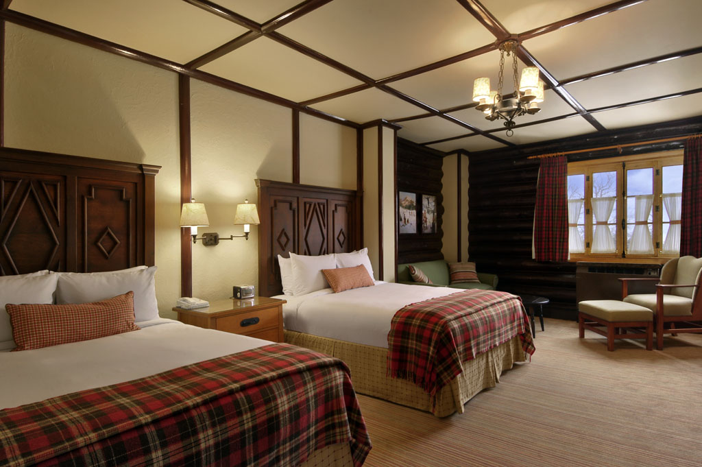 a room with two beds and a lamp