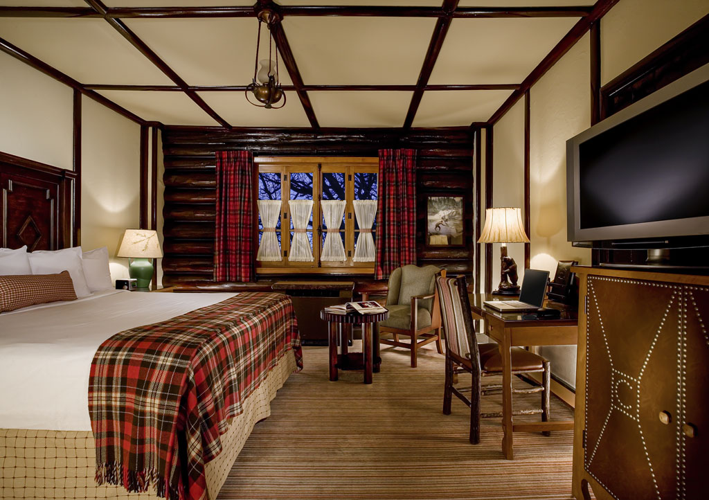 a room with a bed and a television