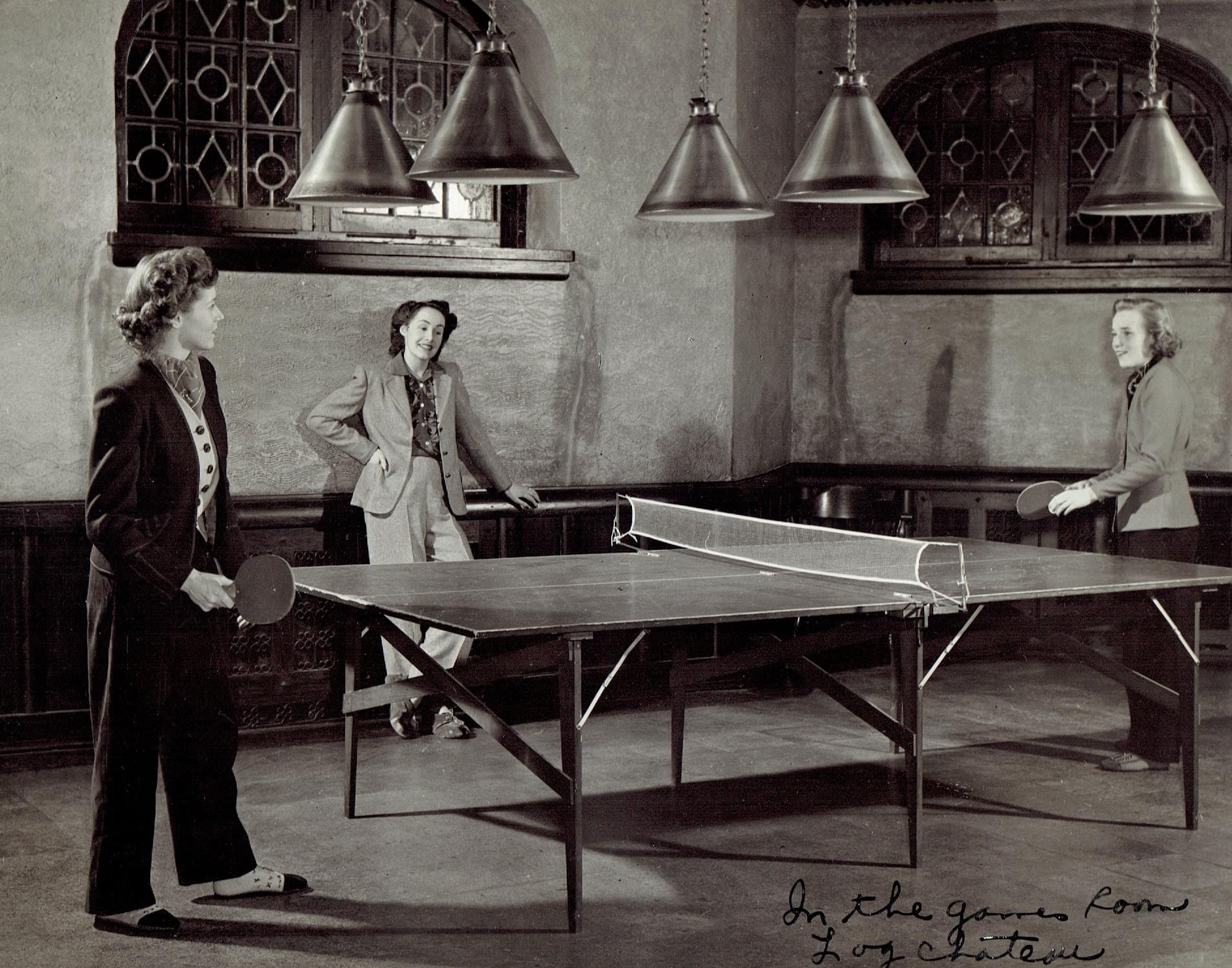 a group of people playing ping pong