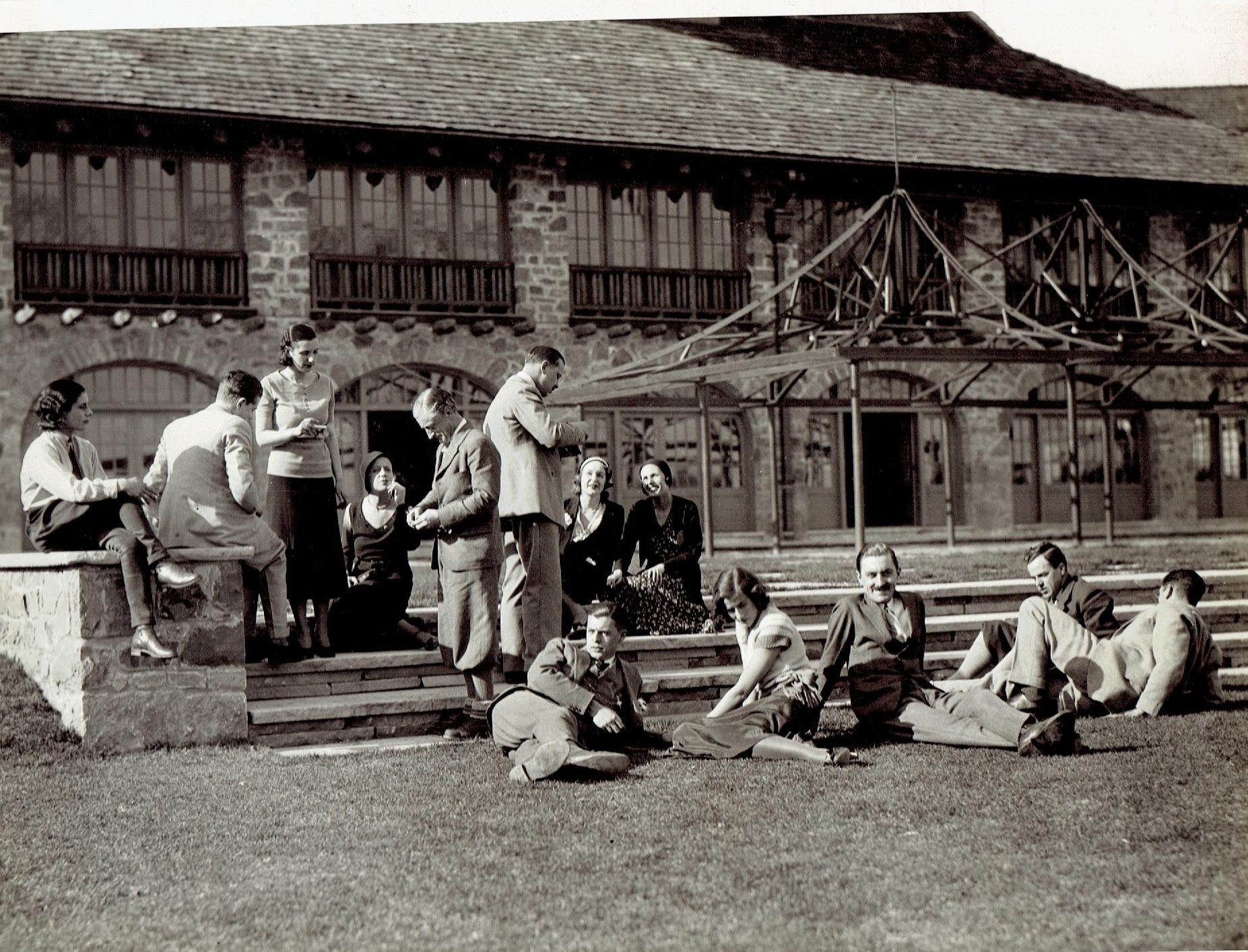 a group of people sitting on the grass