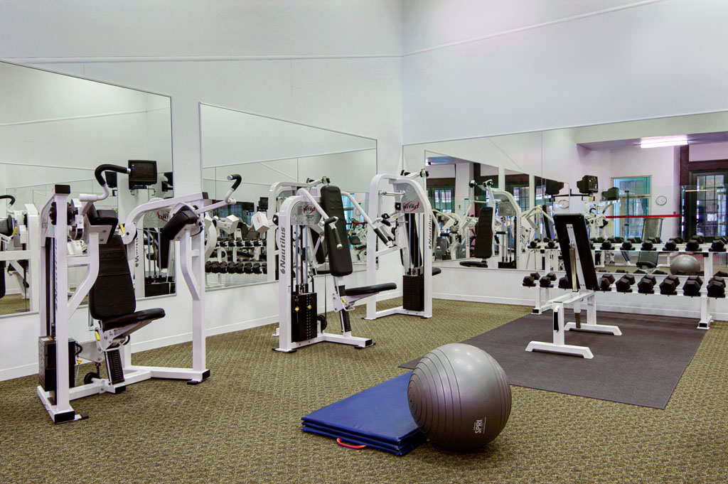 a gym with exercise equipment and a ball