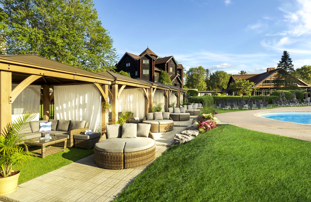 a patio area with chairs and a lawn