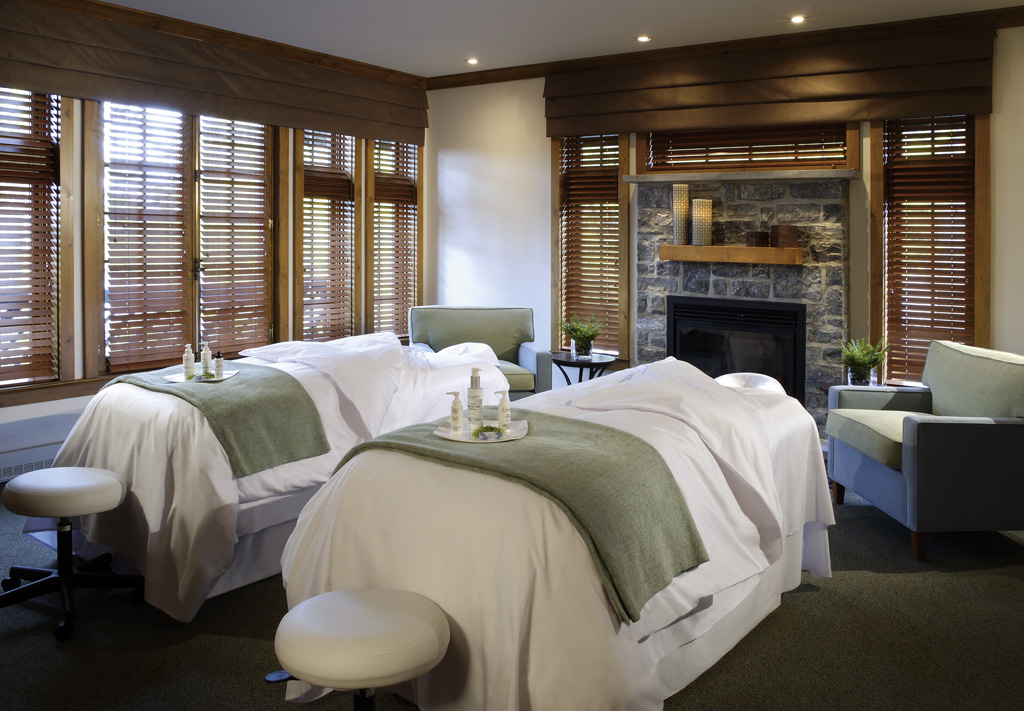 a room with two beds and a fireplace