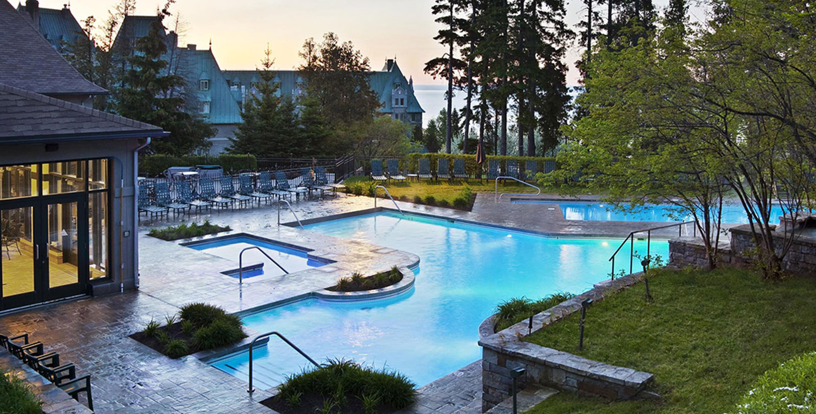 a swimming pool with chairs and trees