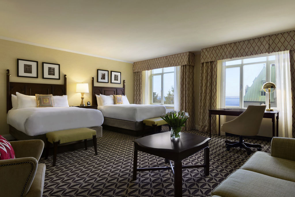 a room with two beds and a couch