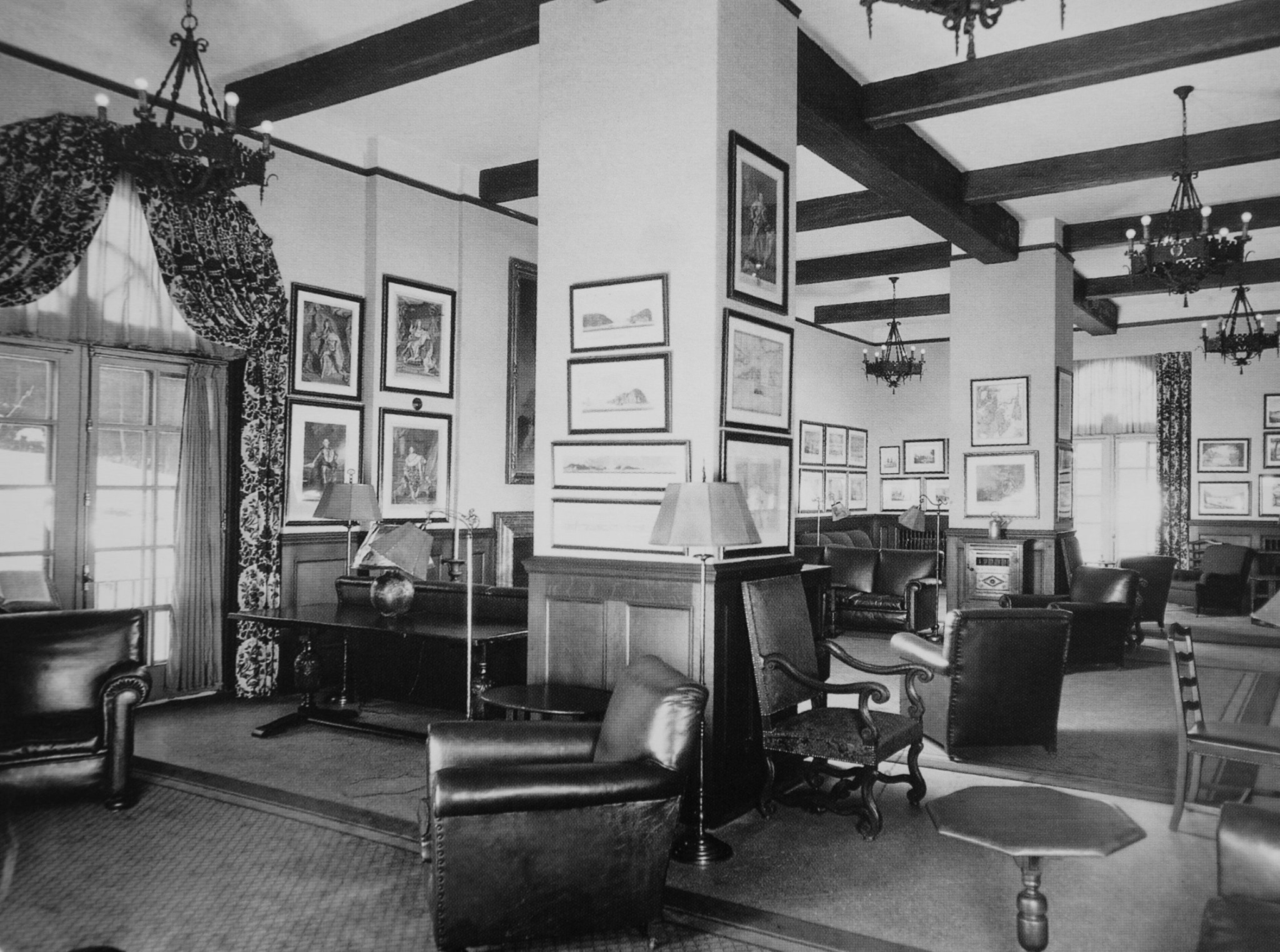 a room with a large column and a chandelier