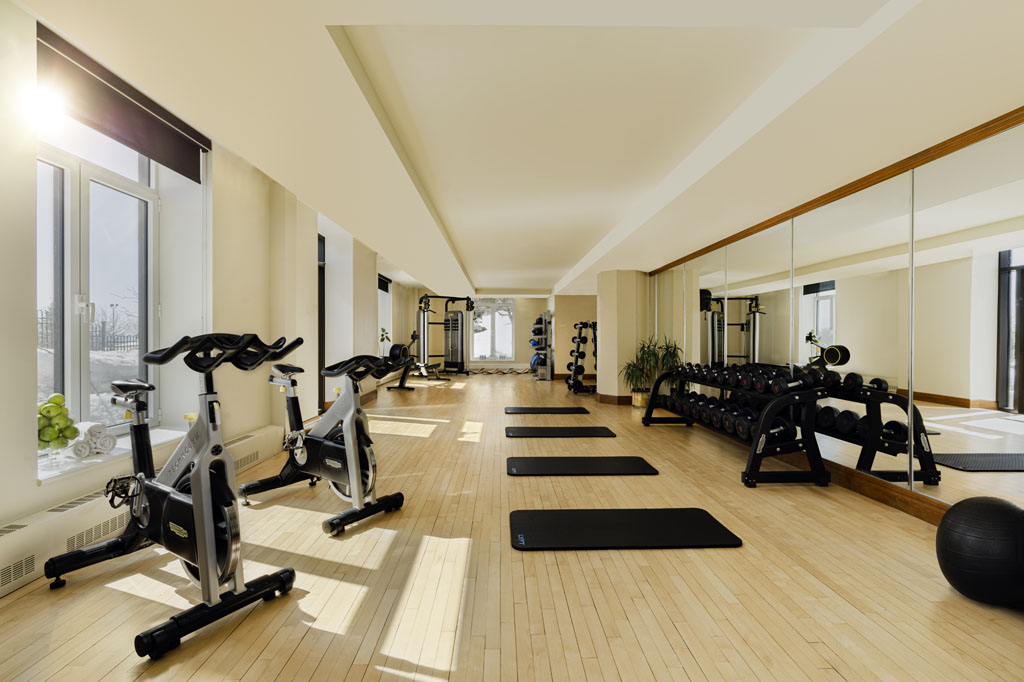 a room with exercise equipment and exercise mats