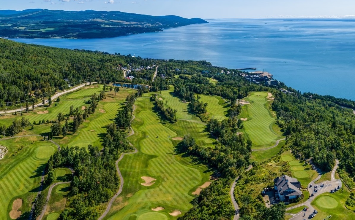 a golf course with a body of water