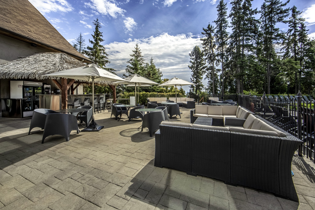 a patio with chairs and umbrellas