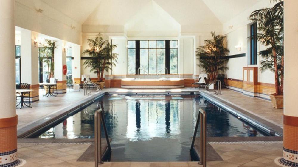a indoor swimming pool with a hot tub