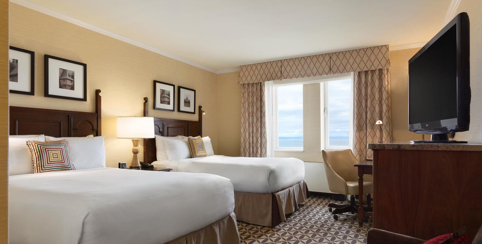 a hotel room with two beds and a desk