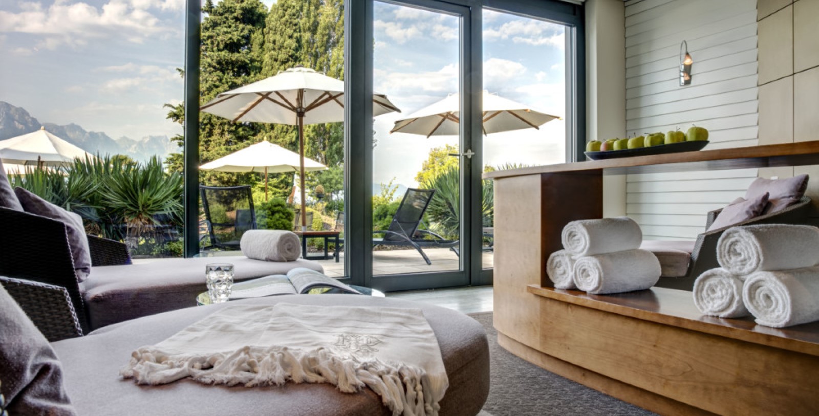 a room with a pool and umbrellas