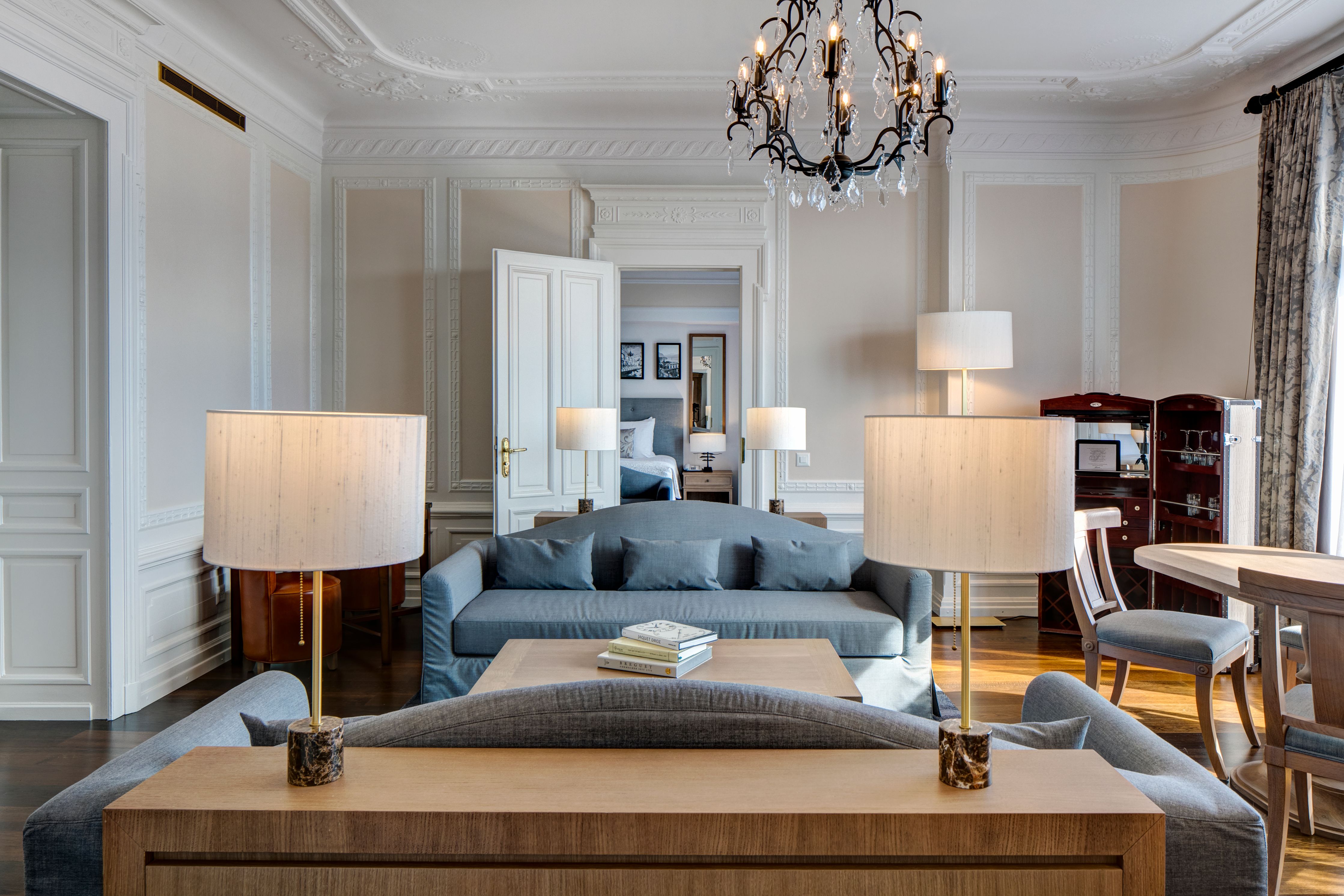 a living room with a chandelier and couches