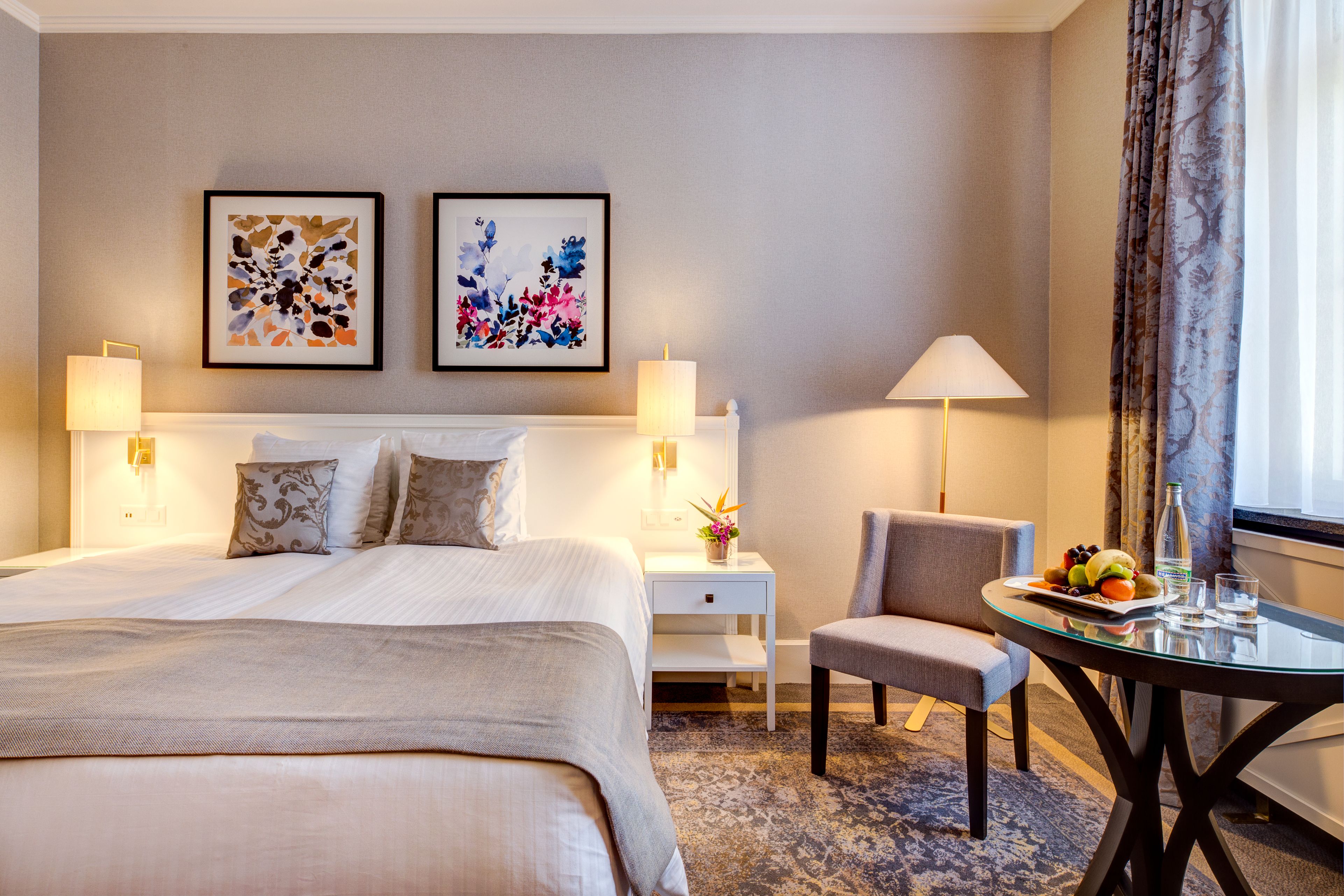 a bedroom with a bed and a table and chairs