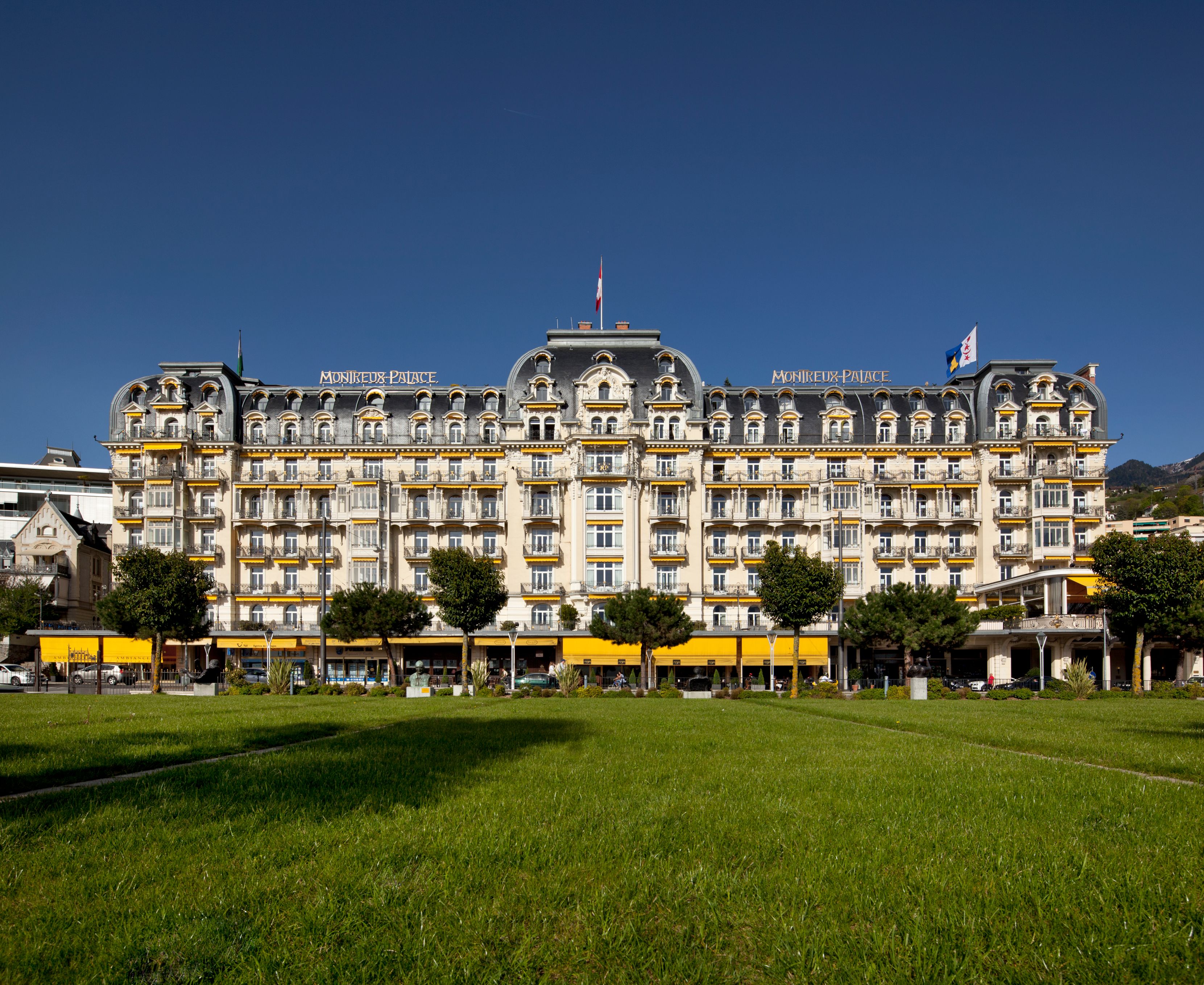 a large building with many windows and a lawn