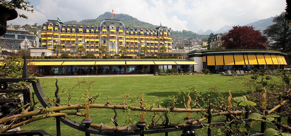 a large building with yellow and white balconies