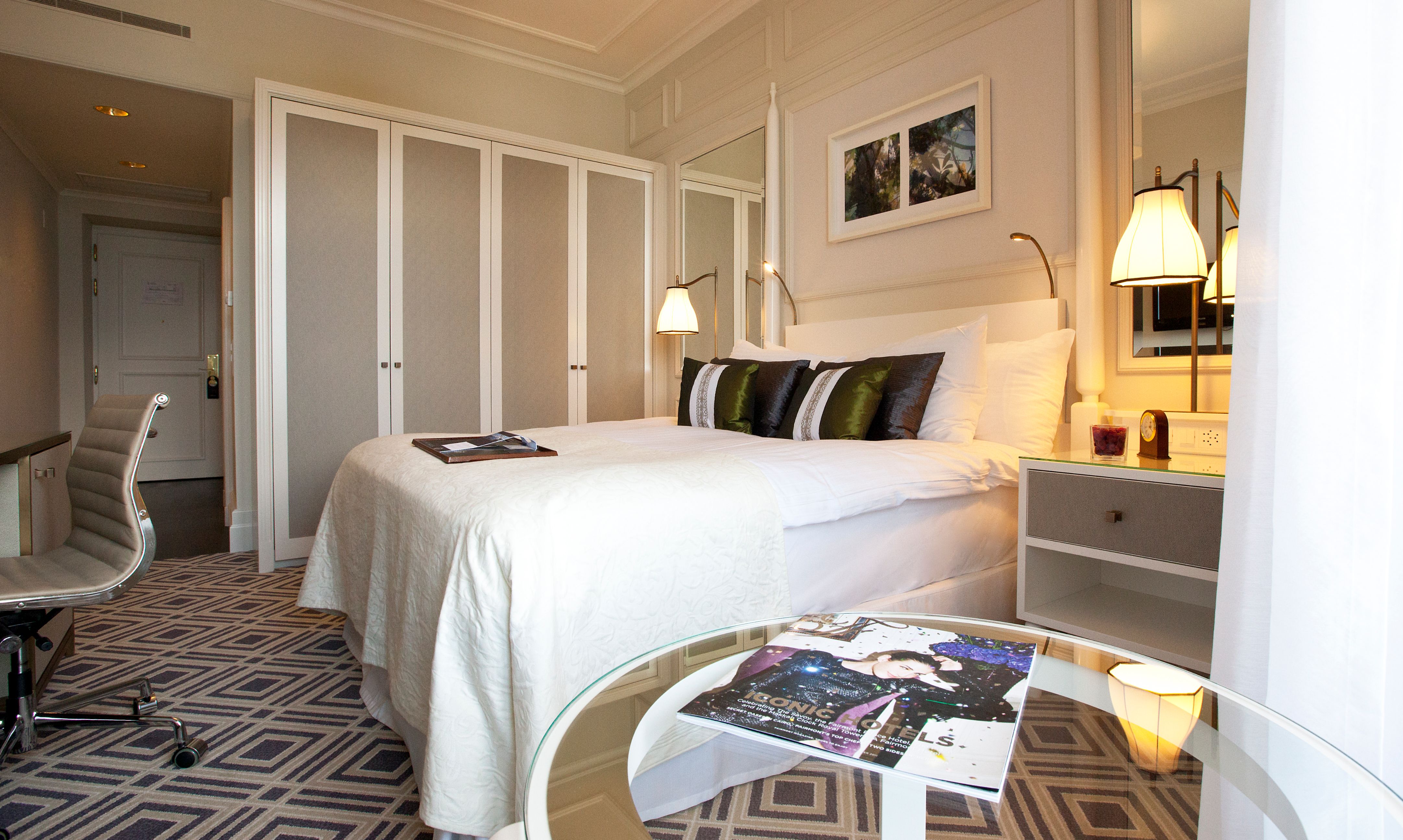 a bedroom with a bed and a glass table