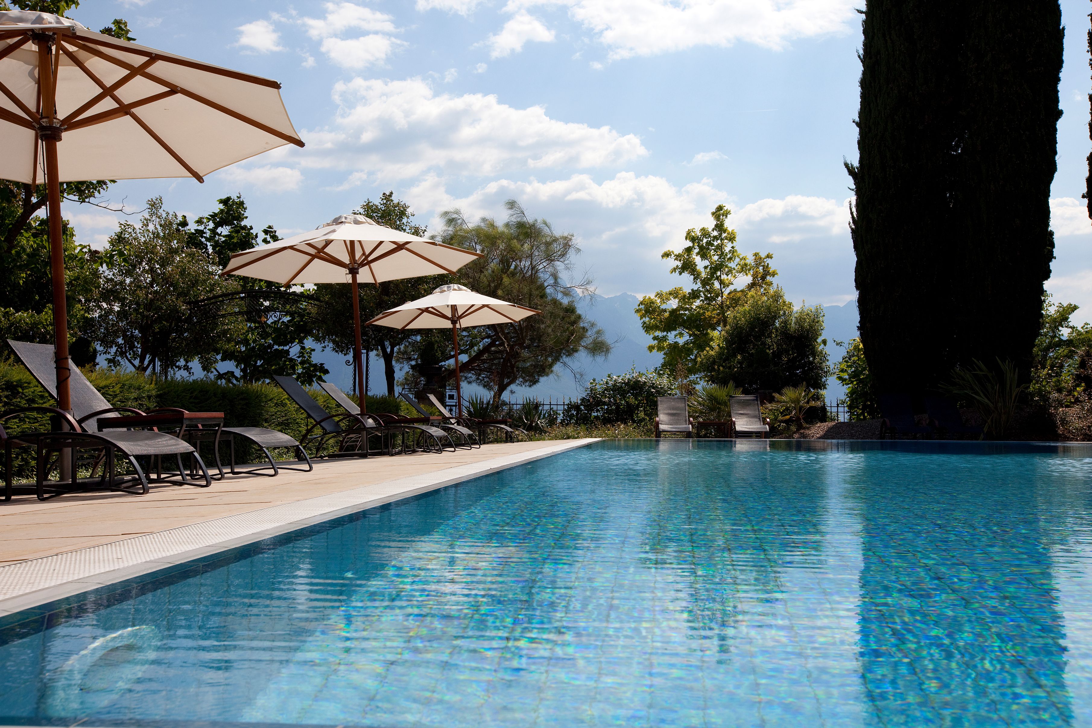 a pool with umbrellas and chairs