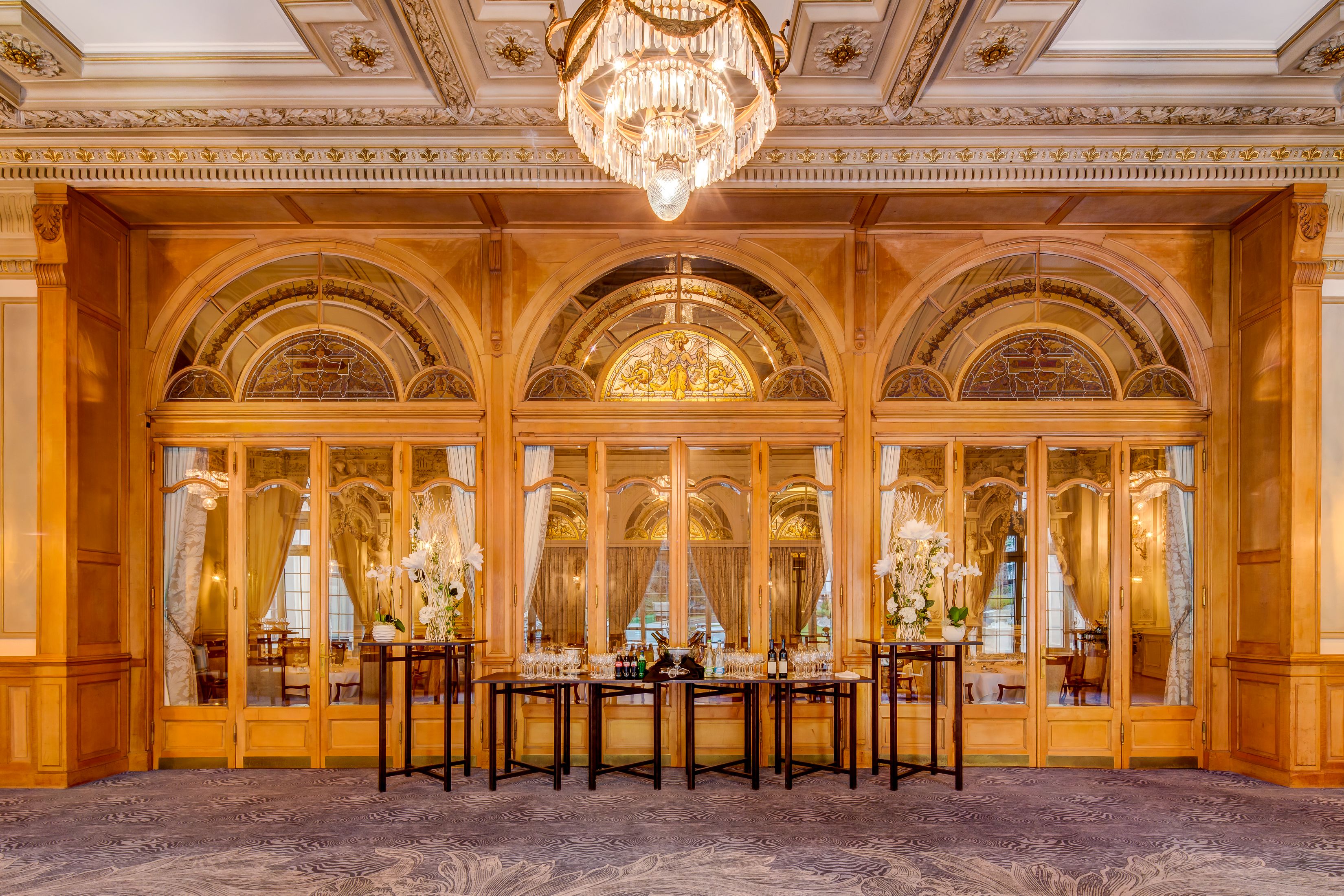 a room with a chandelier and tables
