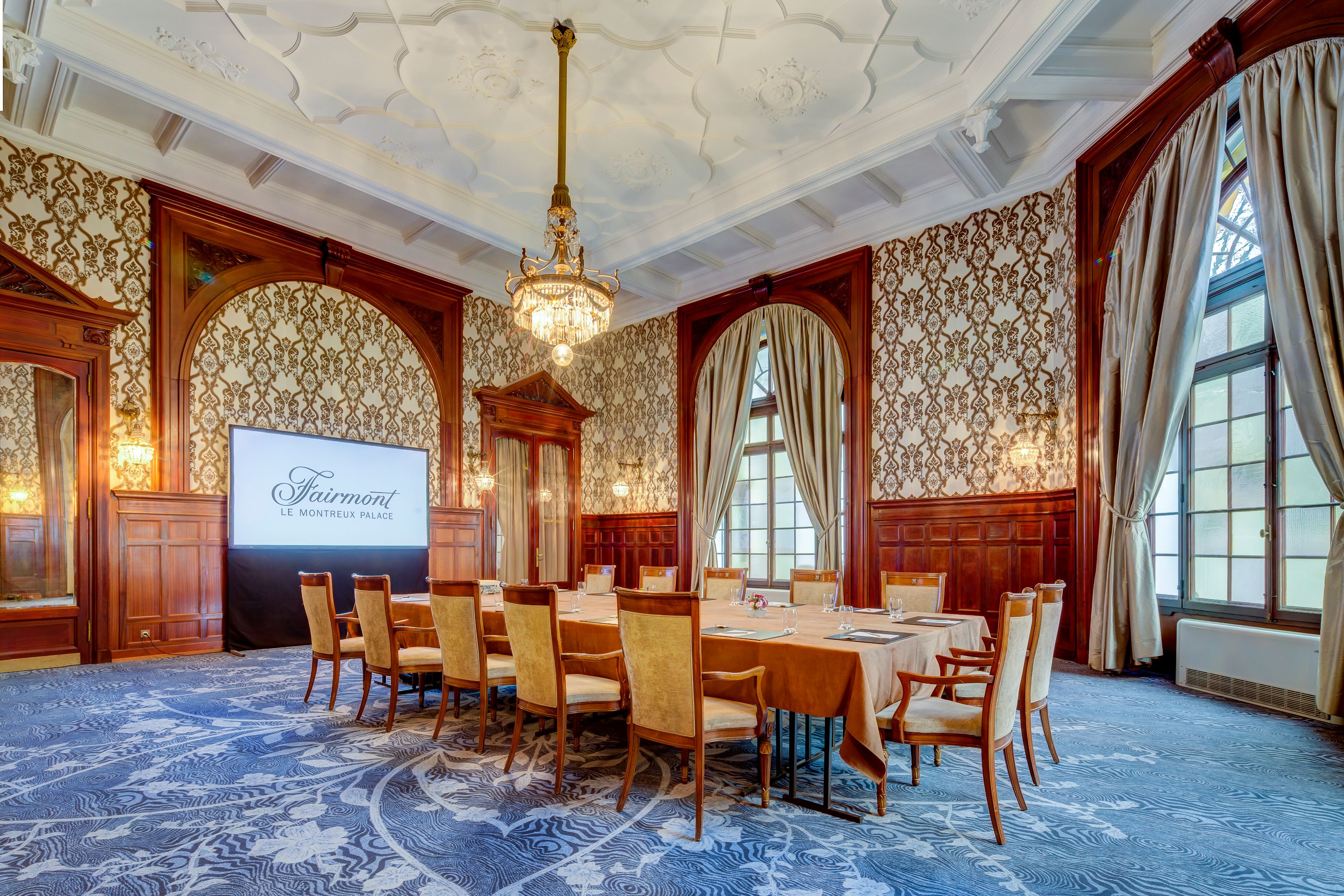 a room with a large screen and a large table