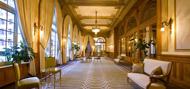 a long room with a large carpeted floor and chairs