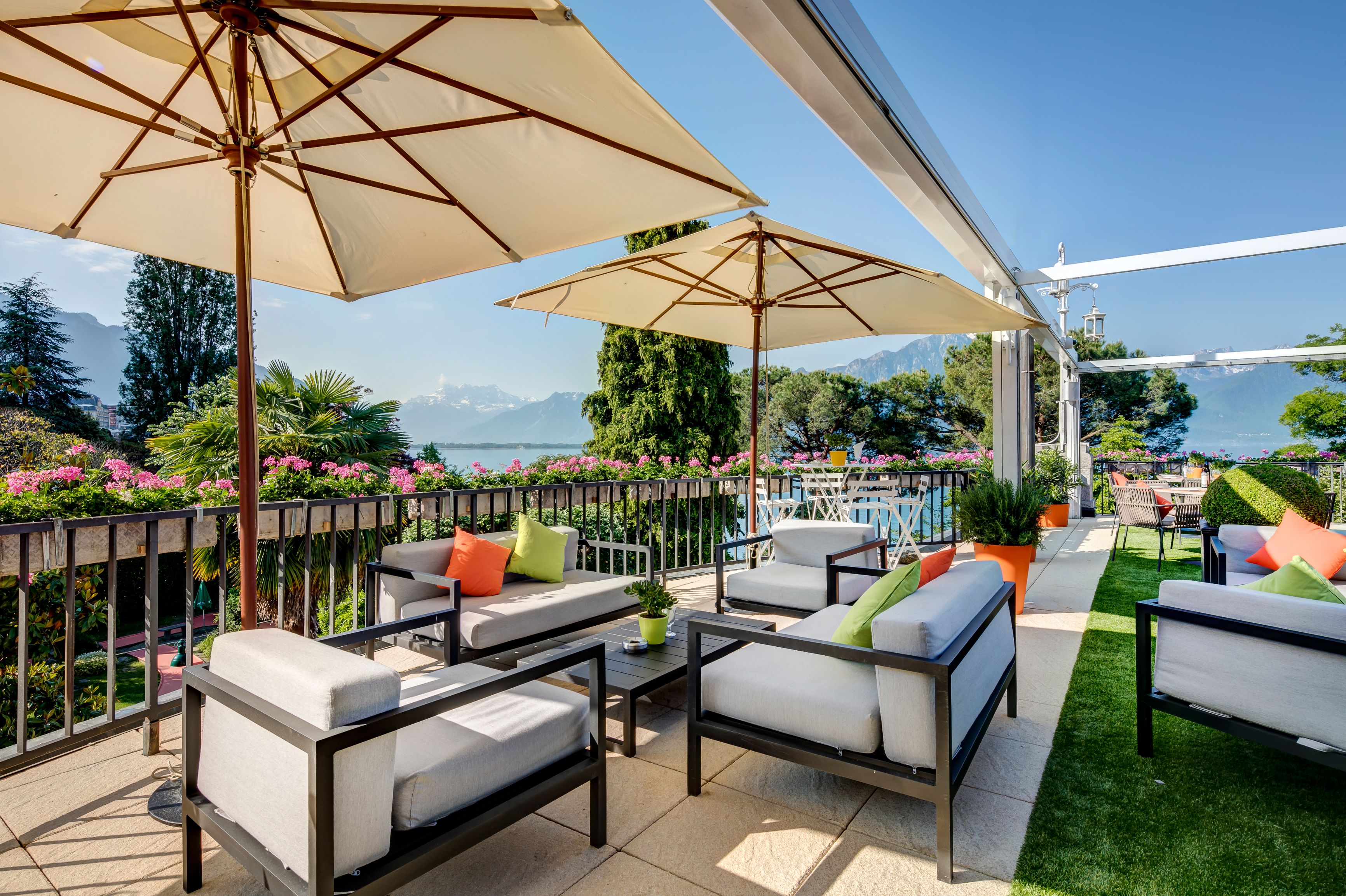 a patio with chairs and umbrellas