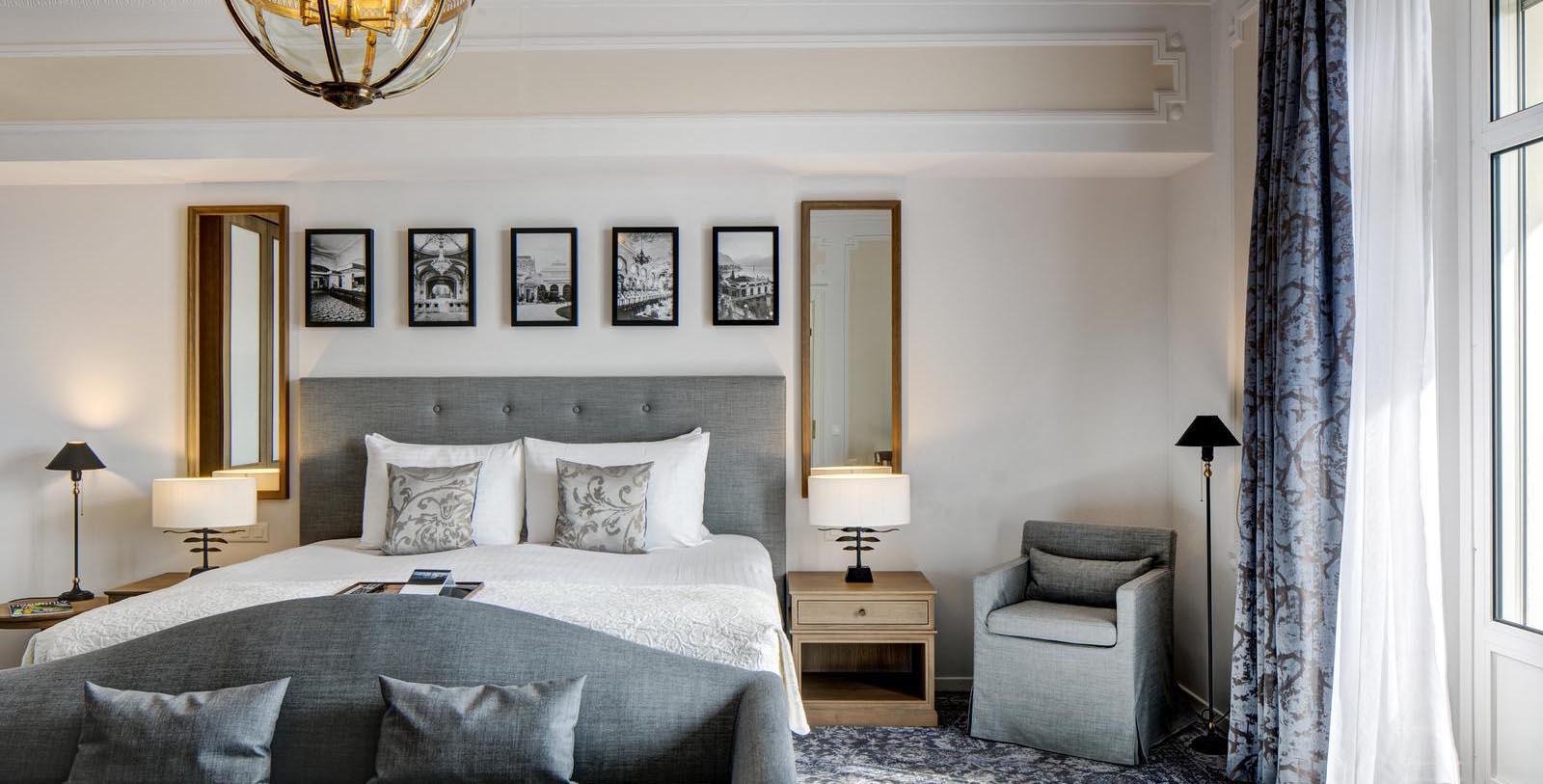 a bedroom with a bed and chairs