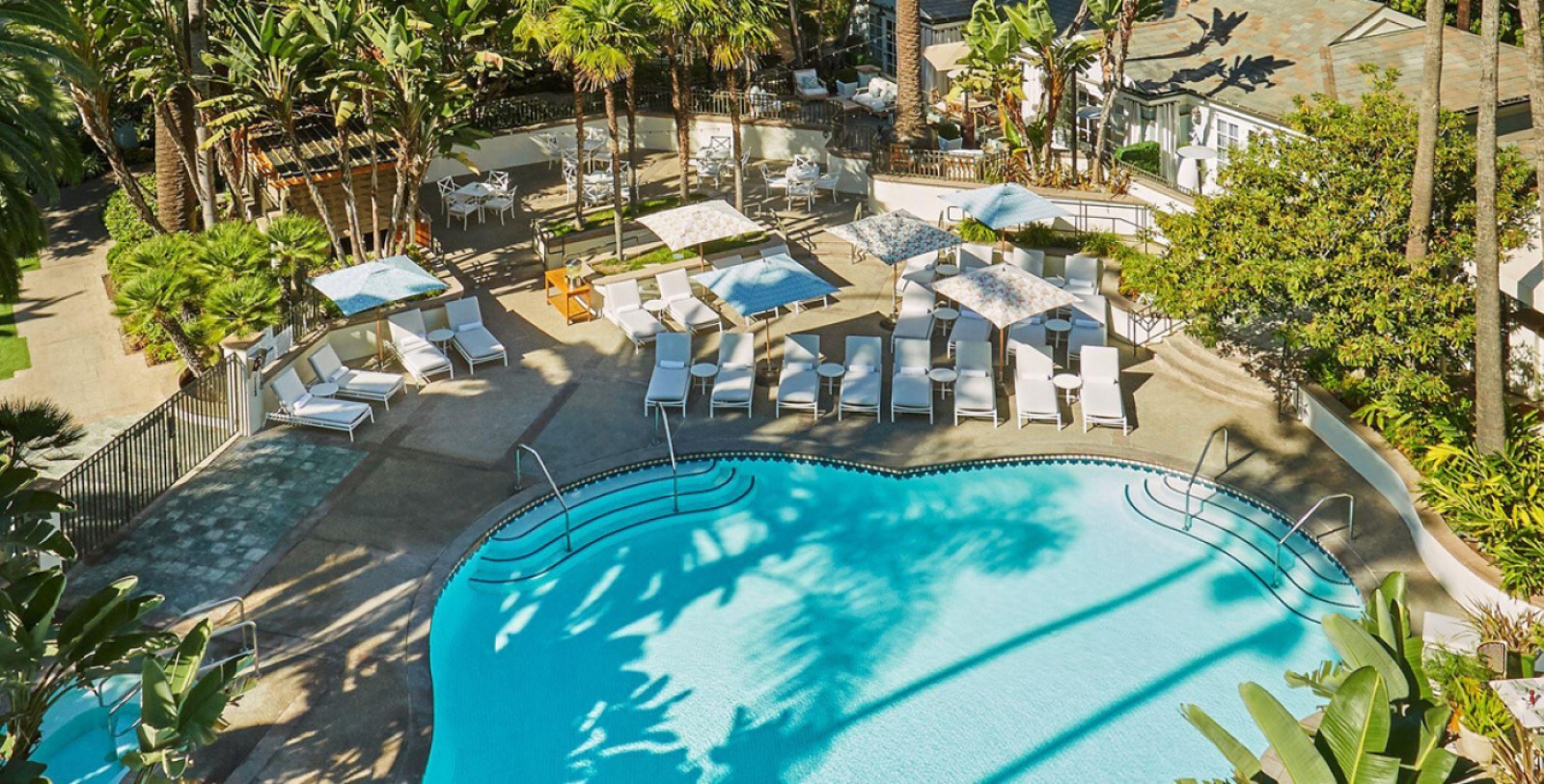 a pool with chairs and tables and chairs around it