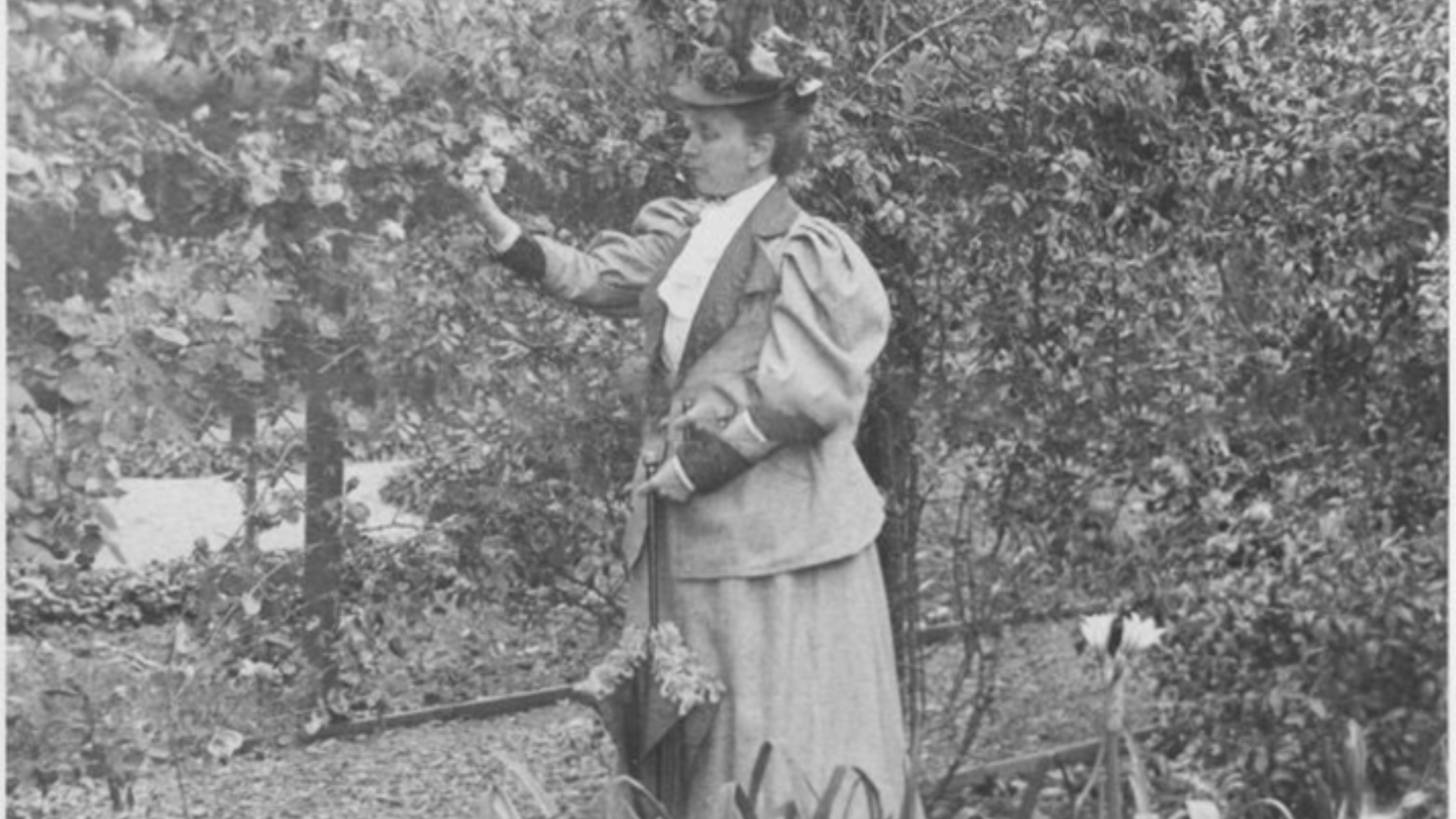 a woman in a suit holding a broom