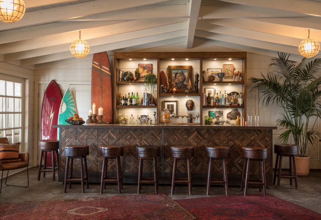 a bar with stools and surfboards