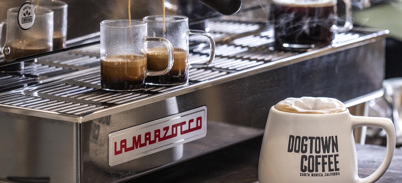a coffee machine with cups of coffee