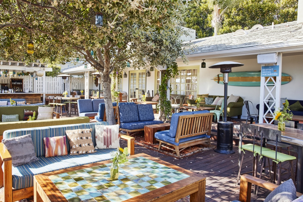 a patio with furniture and tables