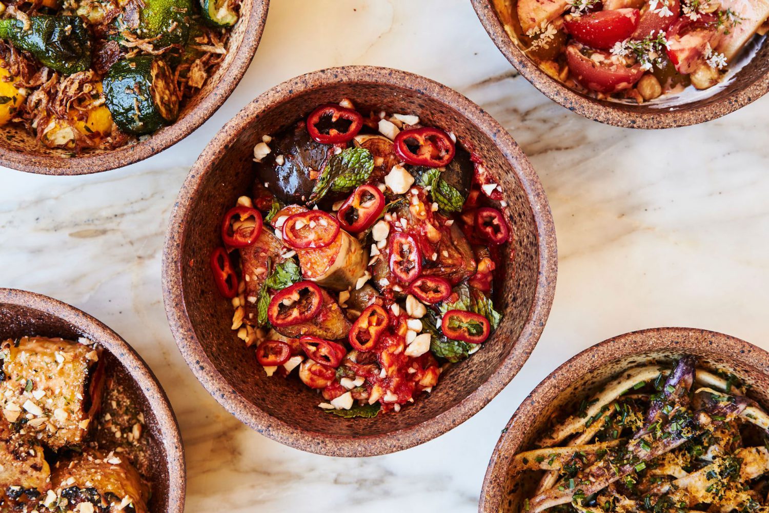 bowls of food on a marble surface