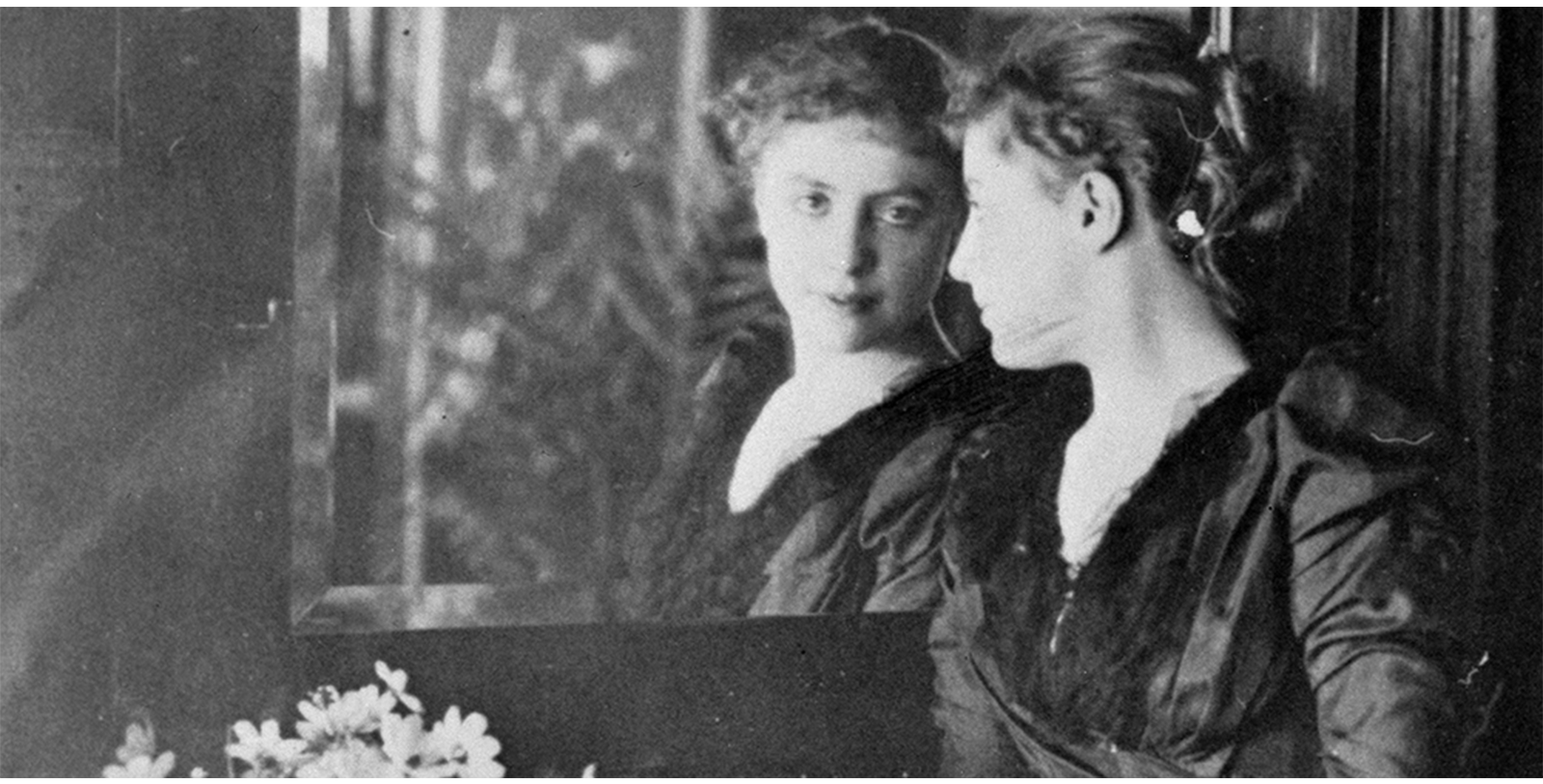 a woman looking at herself in a mirror