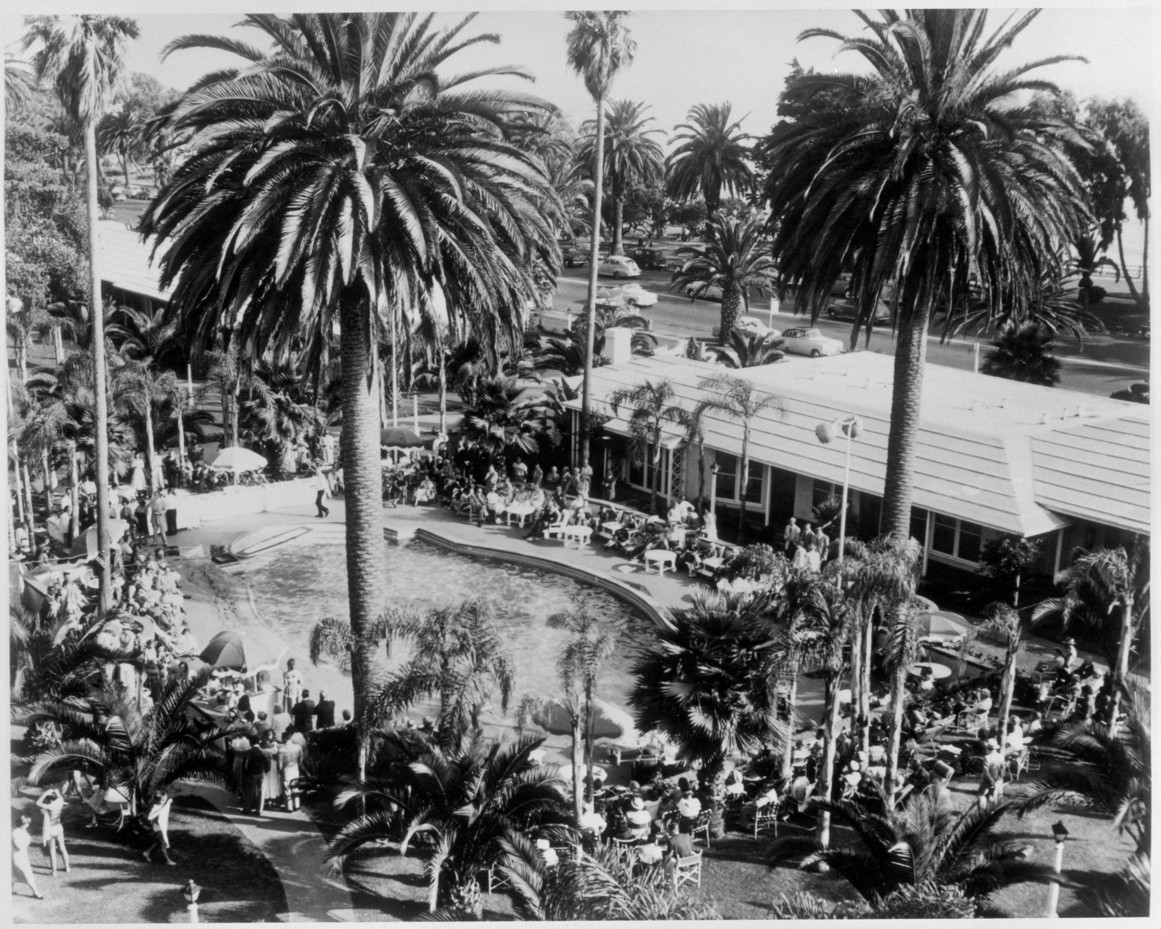 a group of people outside a hotel