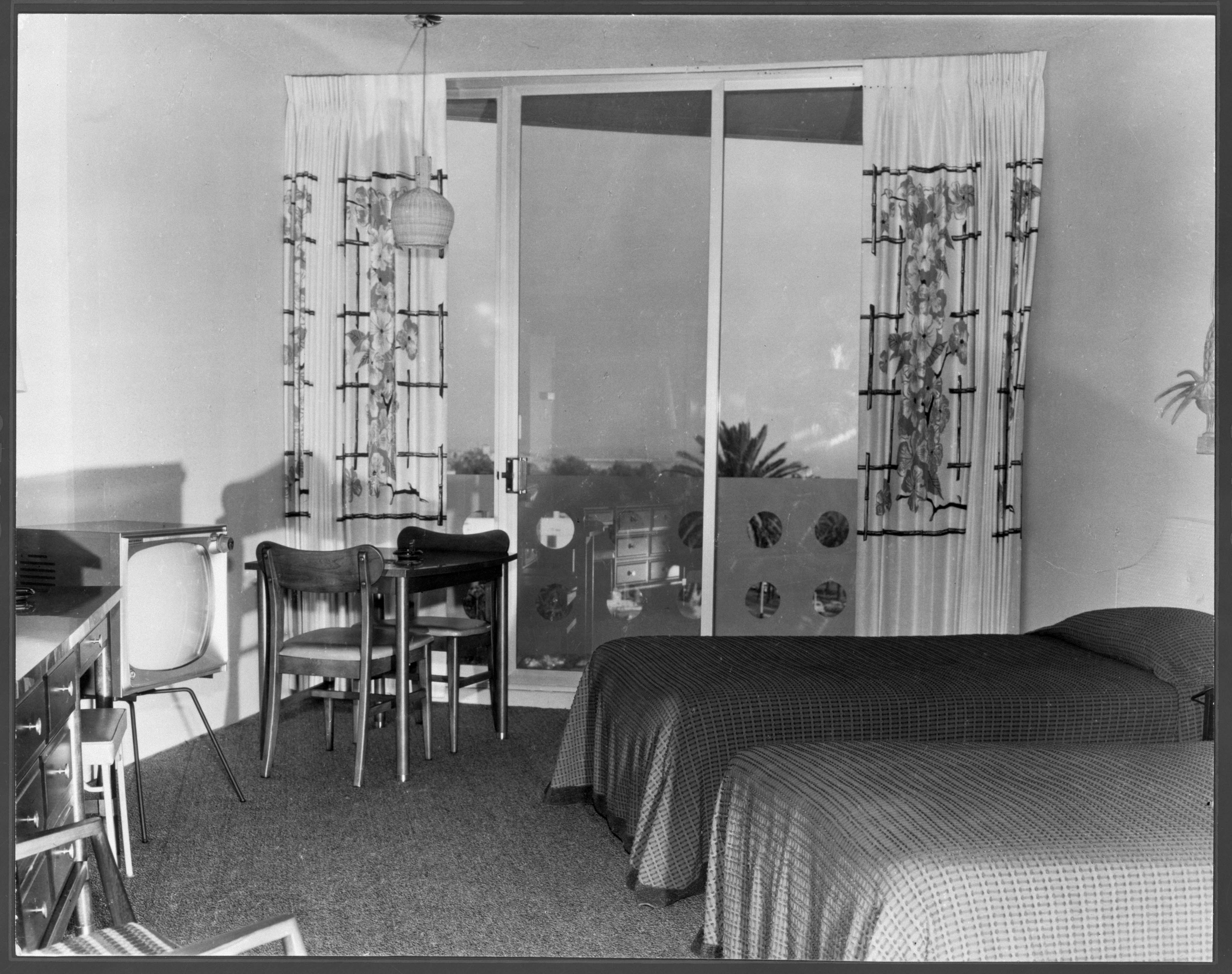 a bedroom with a bed and chairs