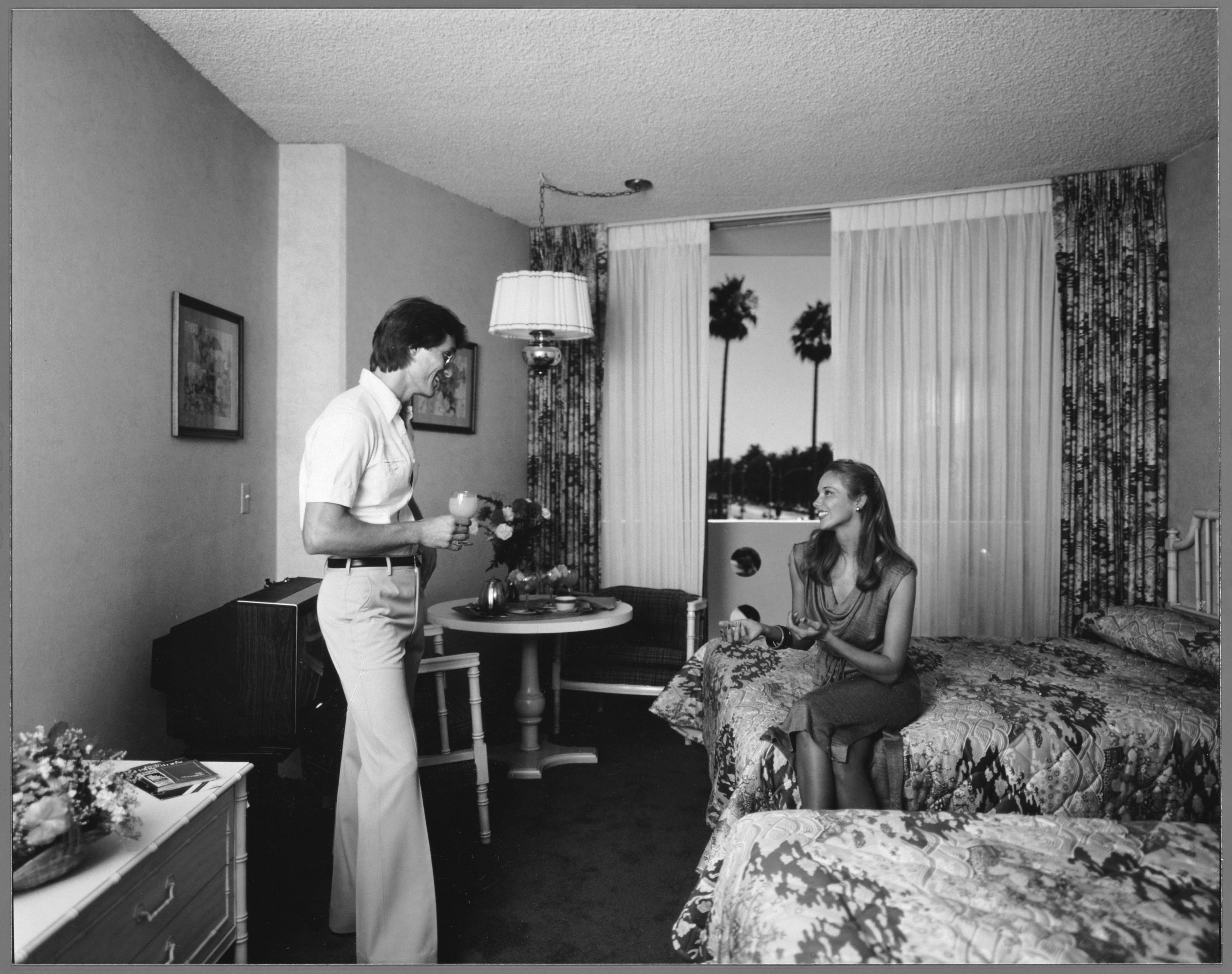 a man and woman in a hotel room