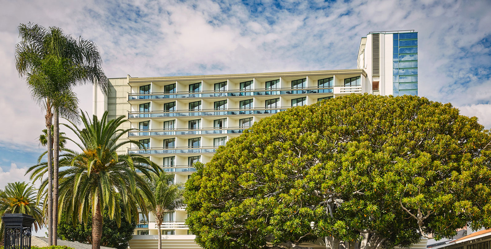 a building with many balconies and trees