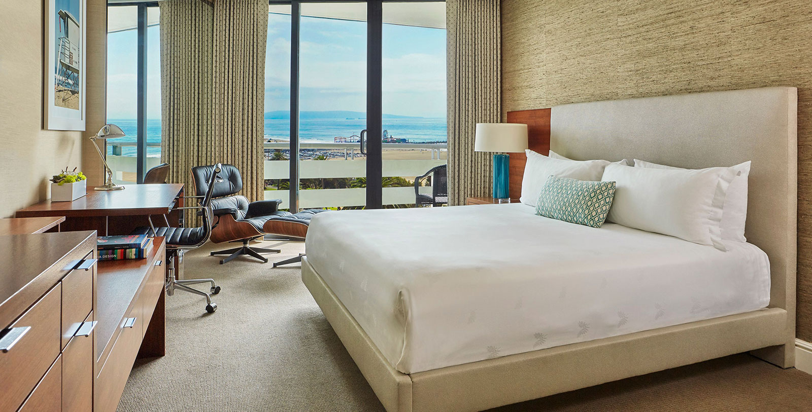 a bedroom with a large bed and a chair