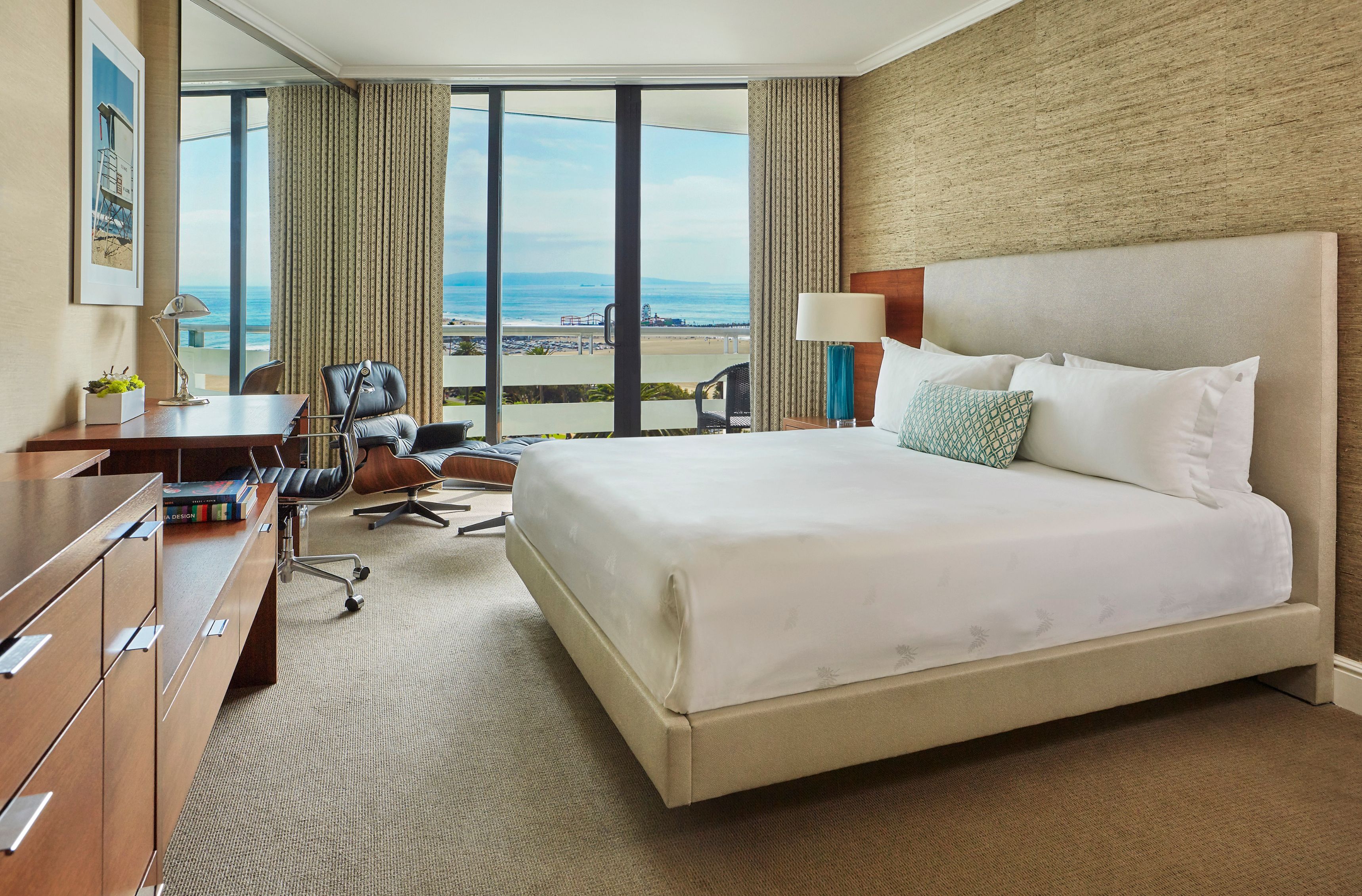 a bedroom with a large bed and a desk