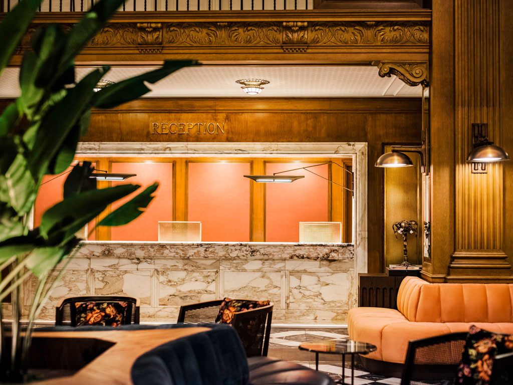 a reception area with a marble counter and chairs