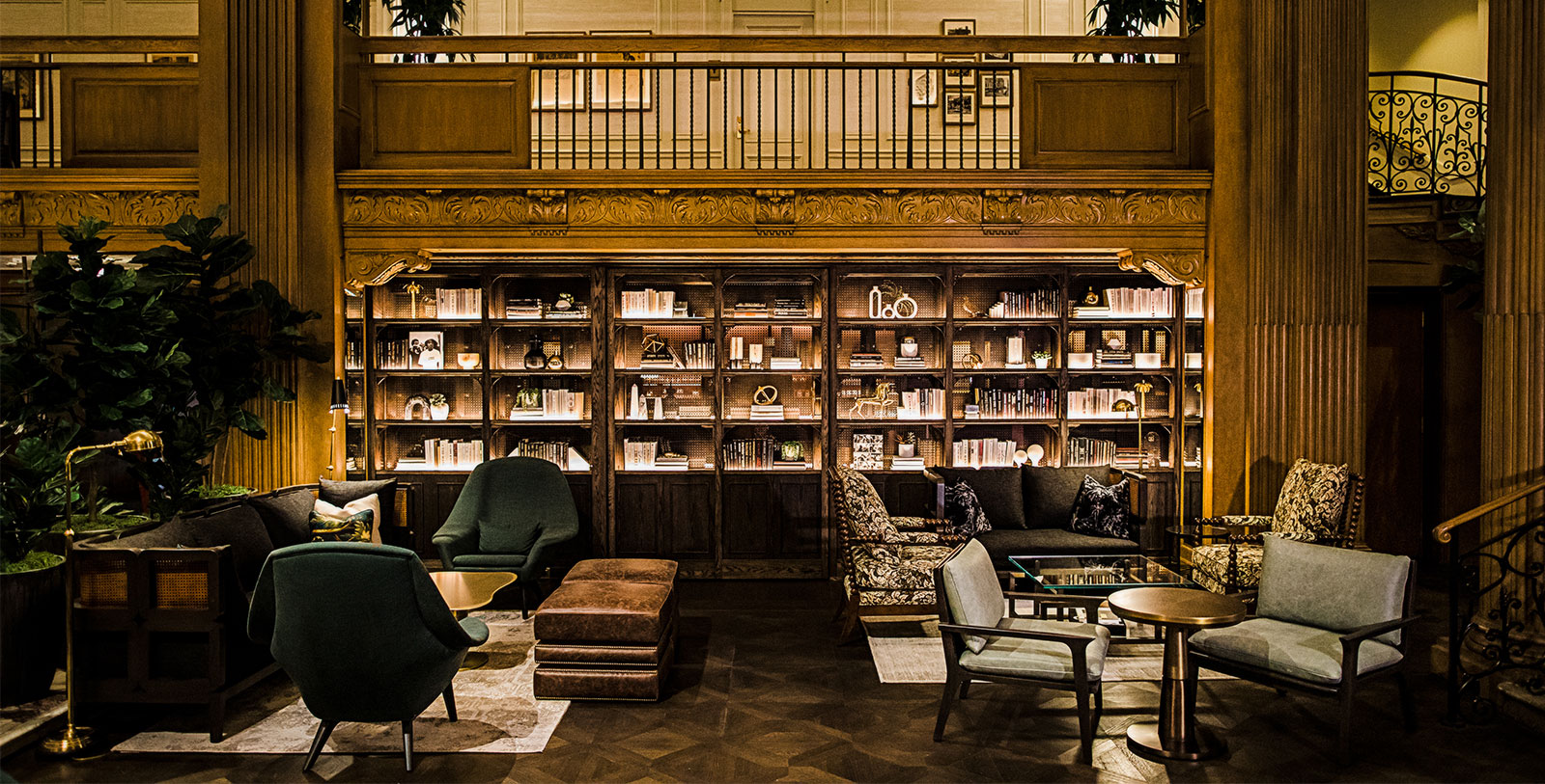 a room with a bookcase and chairs