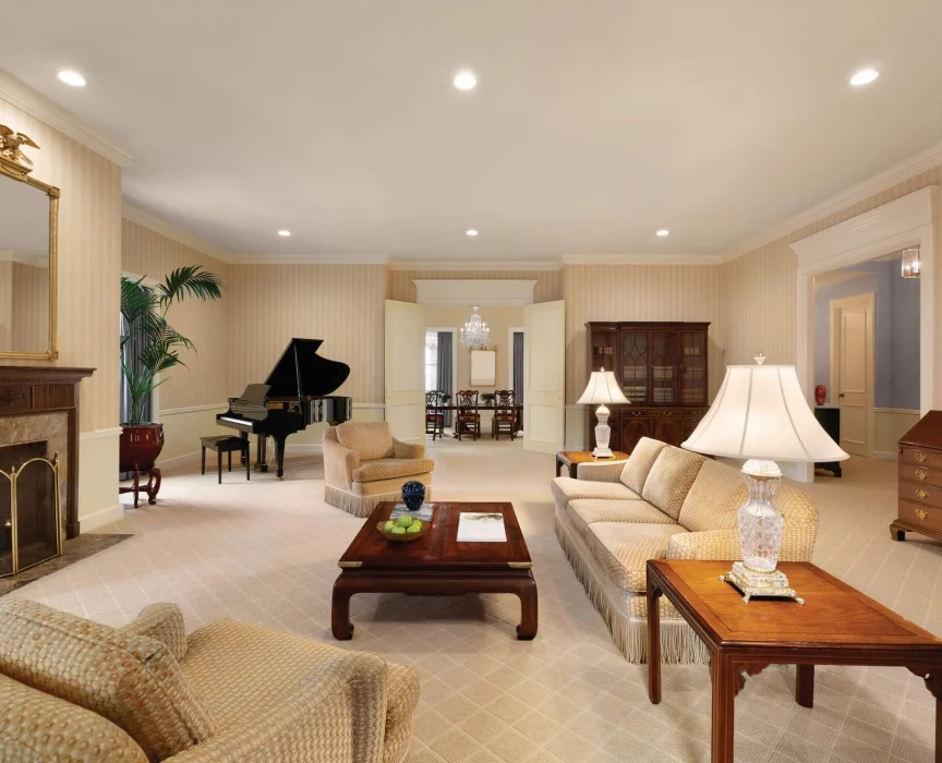 a living room with a piano and couches