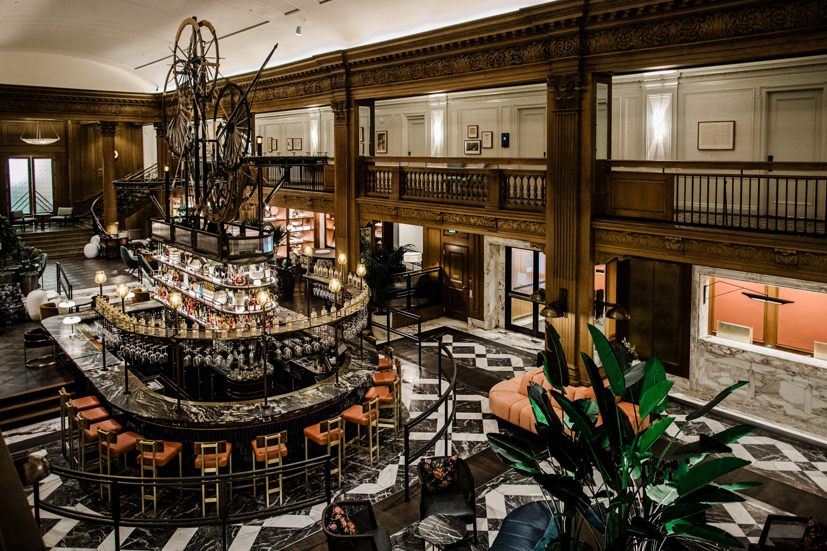 a large room with a bar and a large chandelier