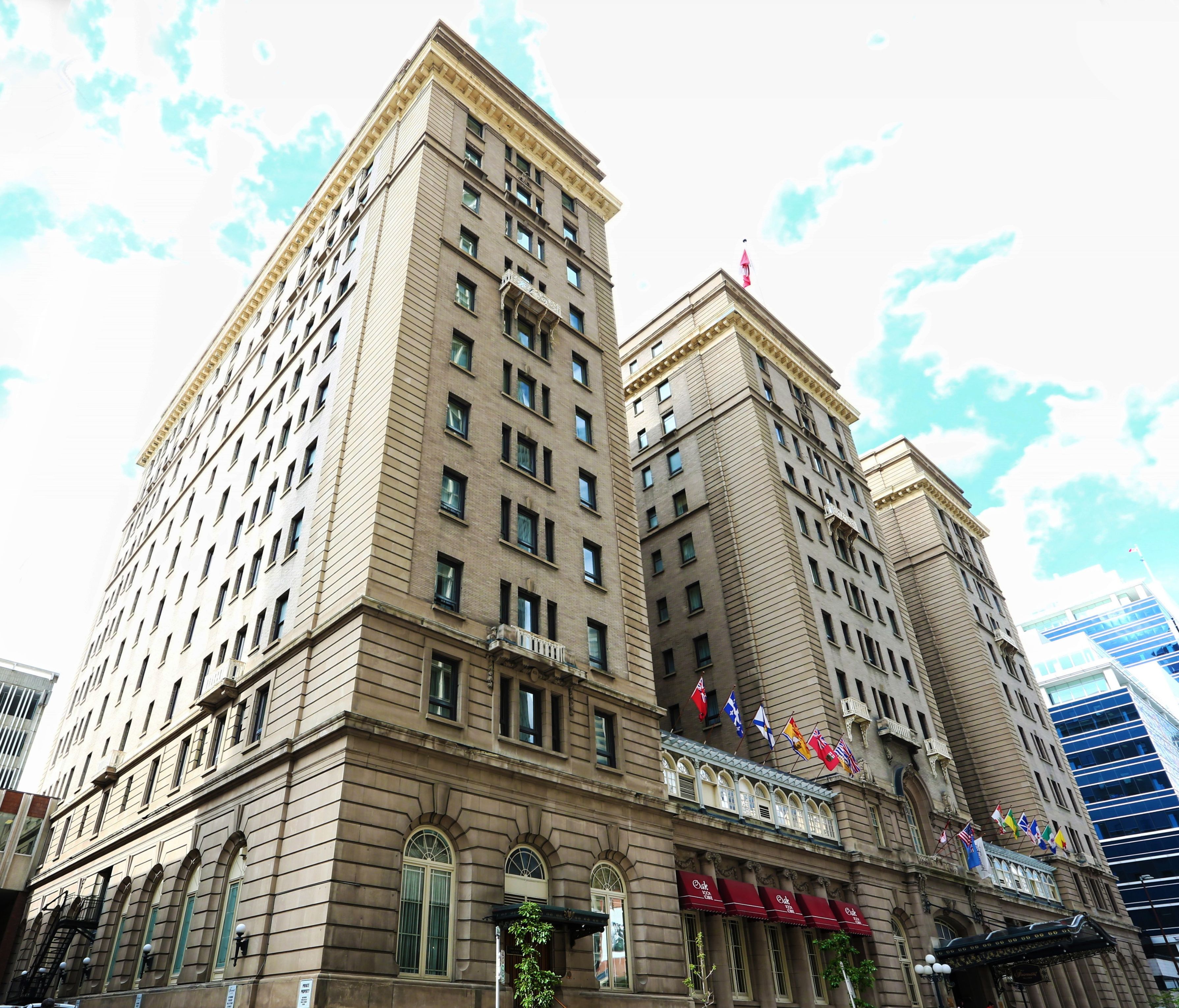 a tall building with flags on the front