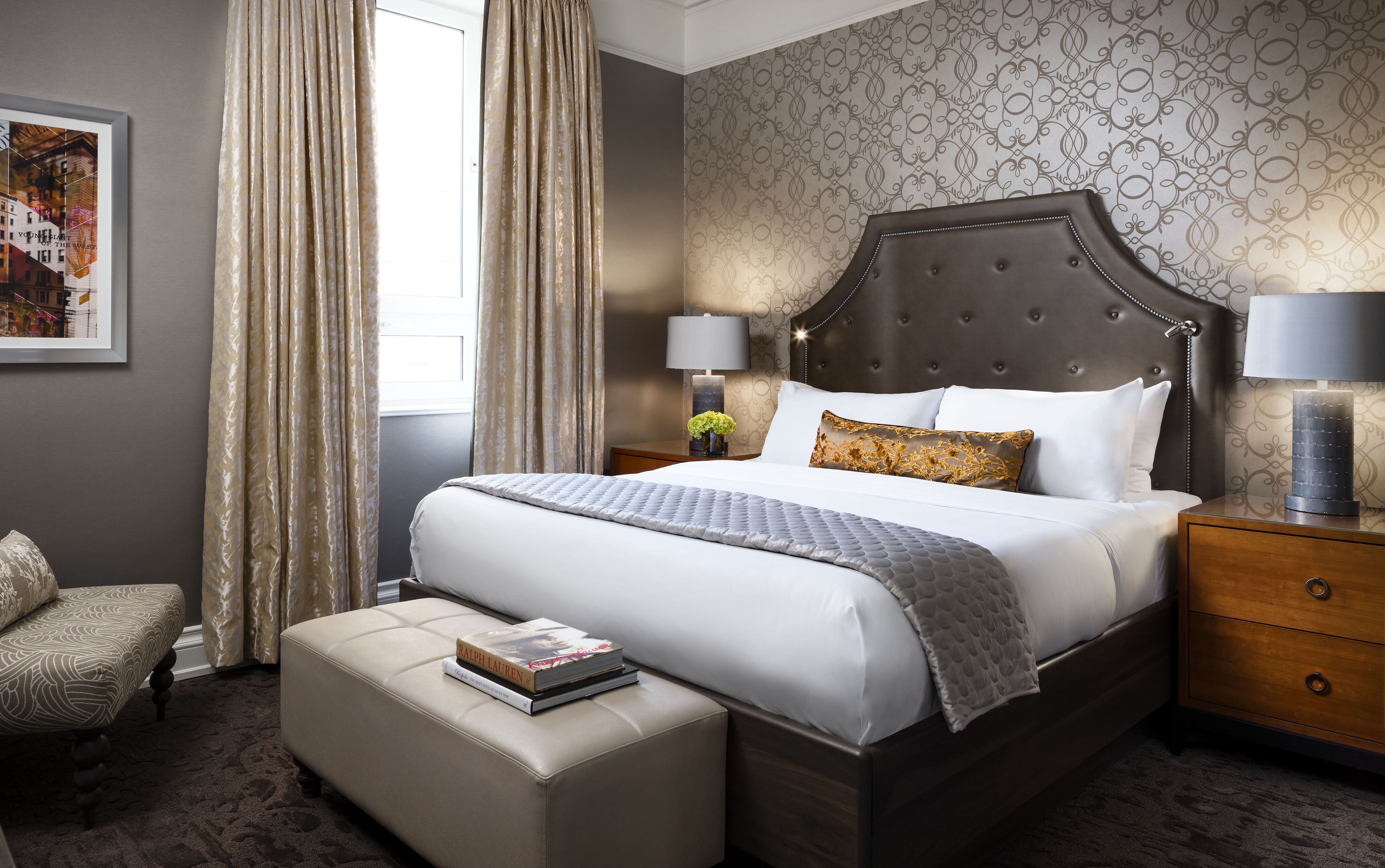 a bed with a foot stool in a room